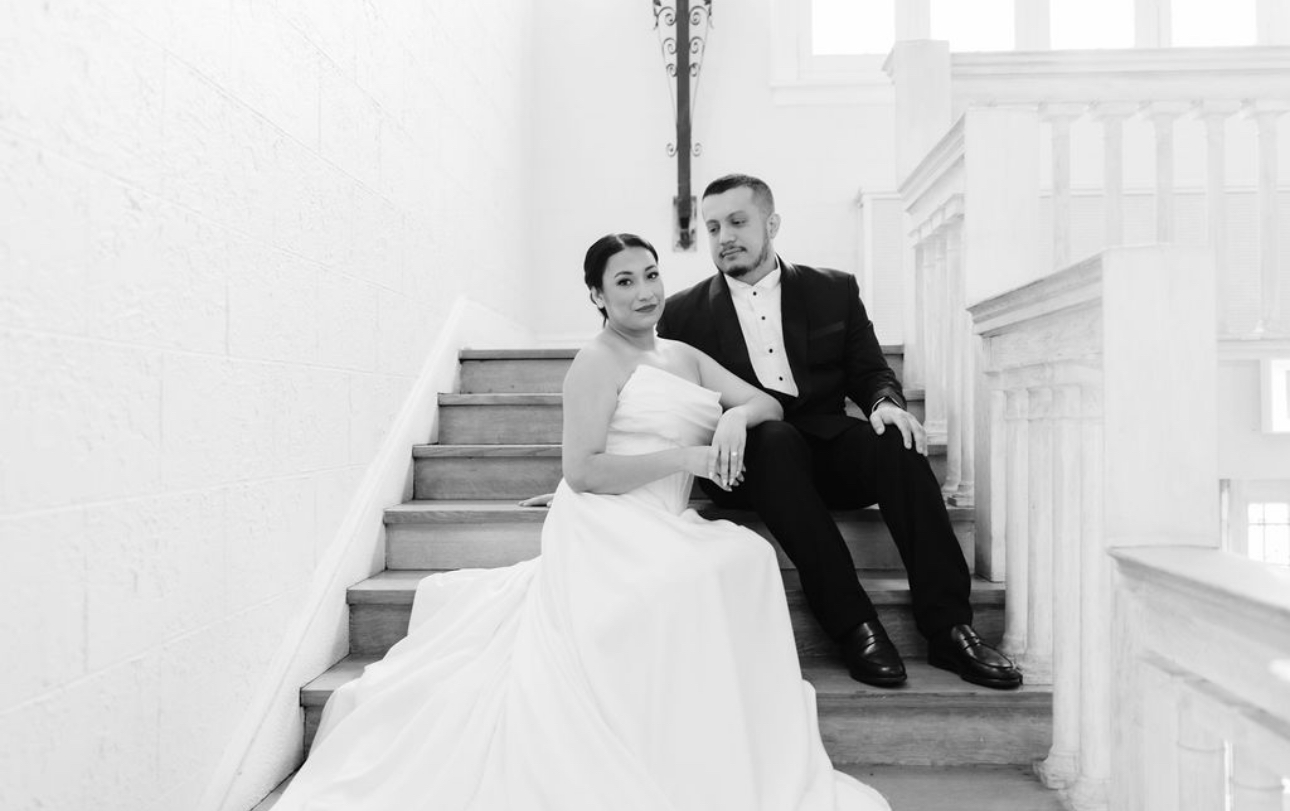 A couple photographed on a staircase after their ceremony